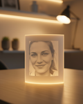 Luminous photo frame with a portrait of a woman on a wooden table.
