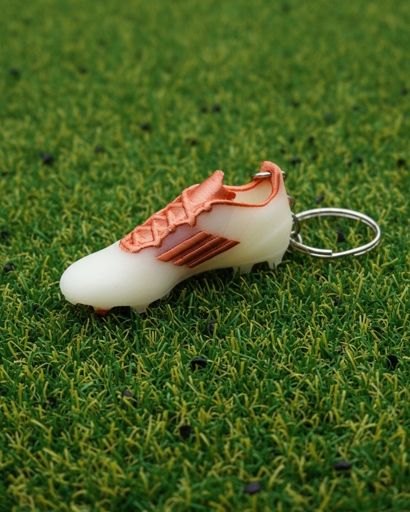 Keychain with a white object and copper accents on a white background