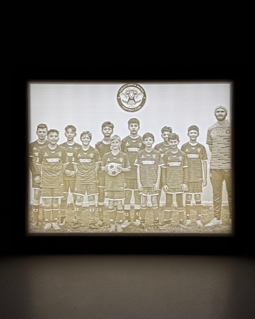 Vintage-style photo of a group of people with a decorative border on a dark background