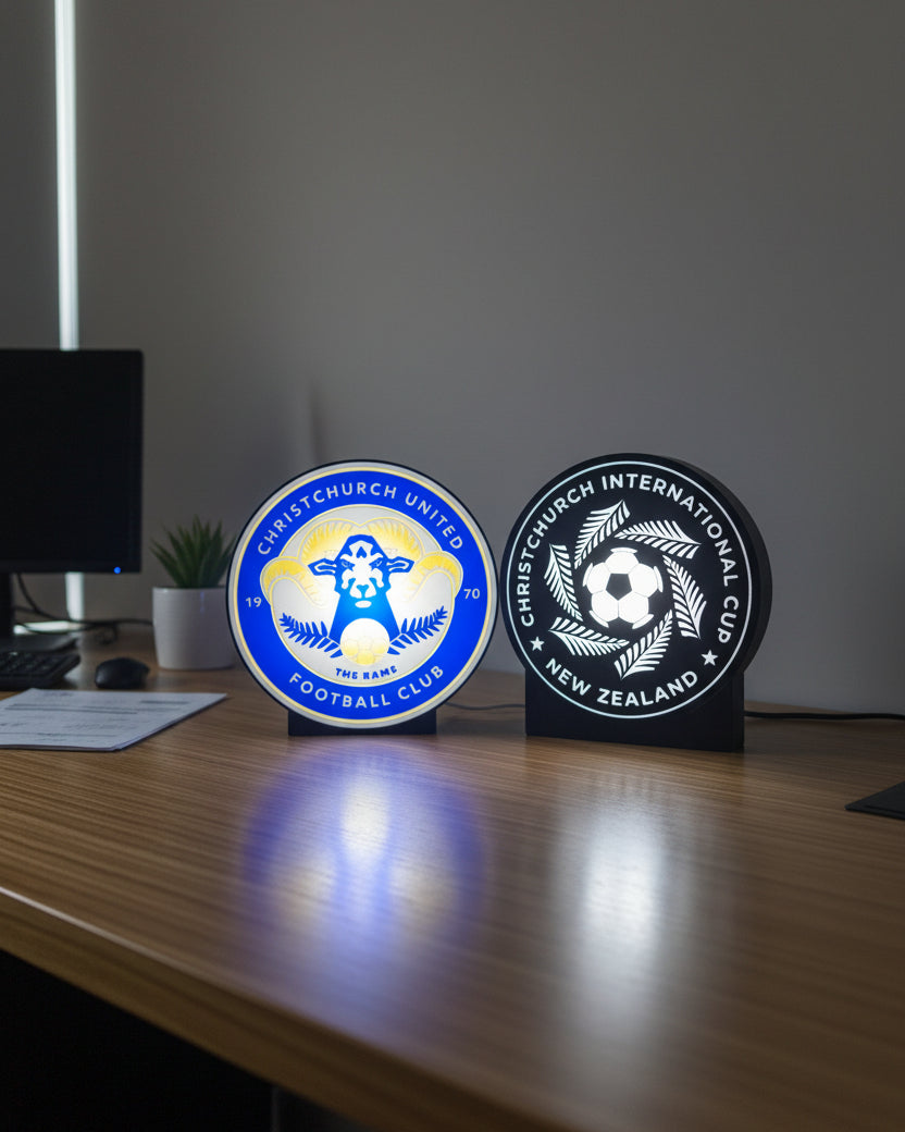 Two sports club logos on a dark background