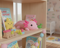 Pink axolotl plush toy on a light gray background