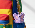 Purple butterfly-shaped toy on a white background