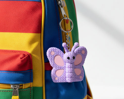 Purple butterfly-shaped toy on a white background