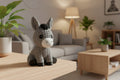 Gray crochet donkey toy on a white background