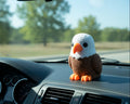 Crocheted eagle toy with white head, brown body, and orange feet and beak on a light gray background