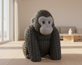 Knitted gorilla toy on a light gray background