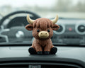 Crocheted toy bull on a white background
