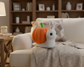 Knitted pumpkin and snail figure on a black background